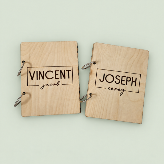 Two wooden greeting card keepers engraved with Vincent and Joseph, with silver binder rings.