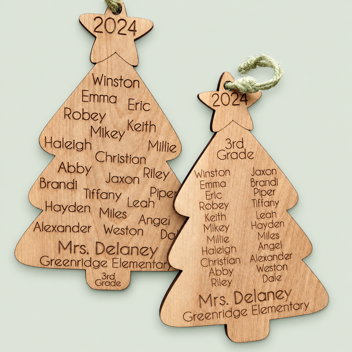 Two wooden Christmas tree ornaments engraved with a teacher's name, class roster and year.