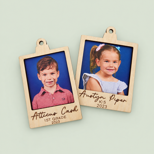 Two wooden school-photo ornaments personalized with children's names, grades and year.