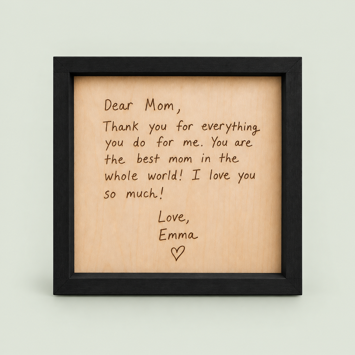 Black-framed wooden keepsake engraved with a Dear Mom letter signed Love, Emma.
