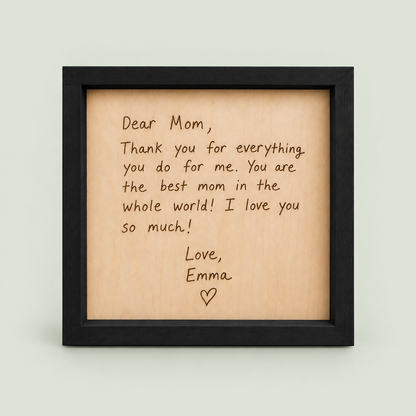 Black-framed wooden keepsake engraved with a Dear Mom letter signed Love, Emma.