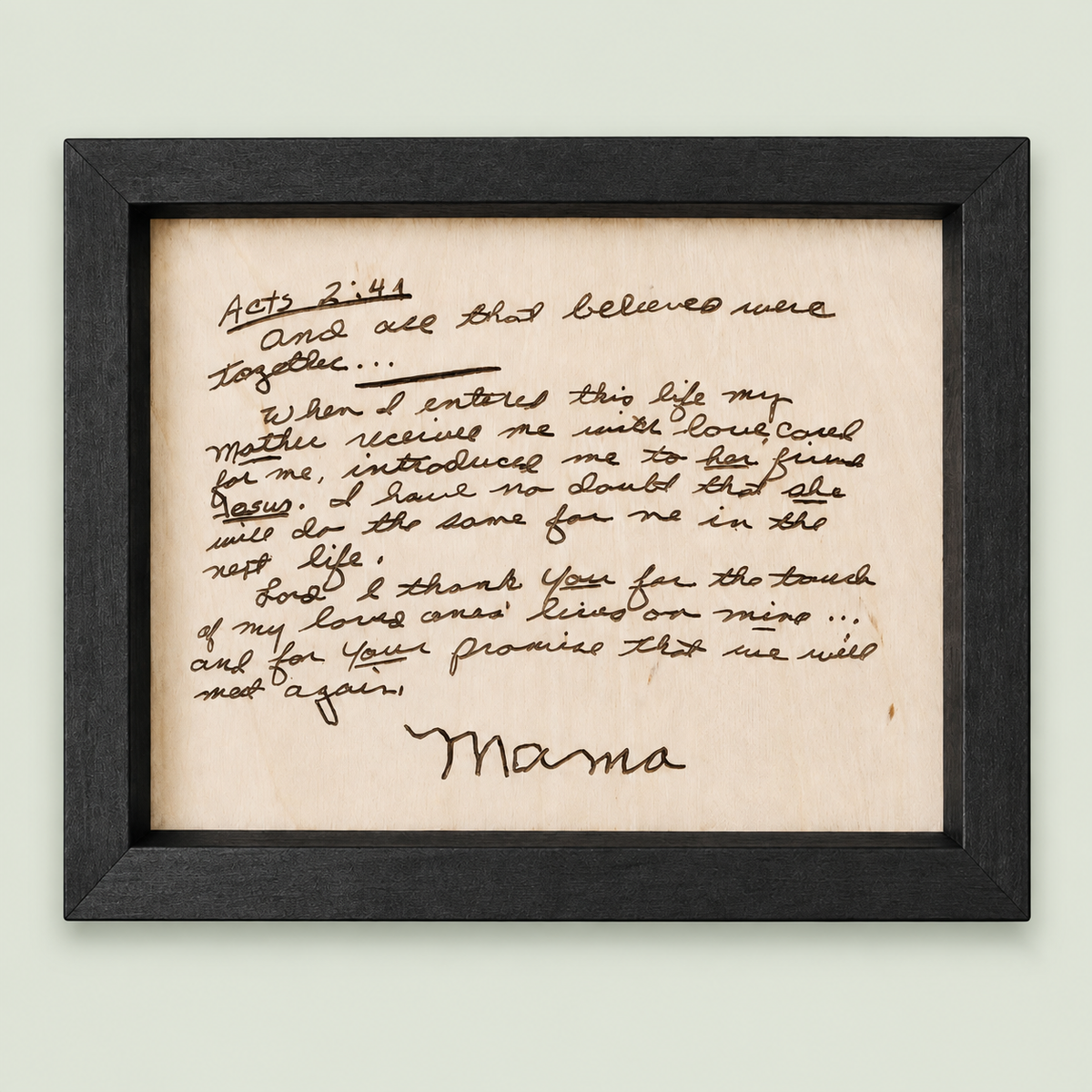 Black-framed wooden memorial keepsake engraved with a handwritten letter signed Mama on soft sage.
