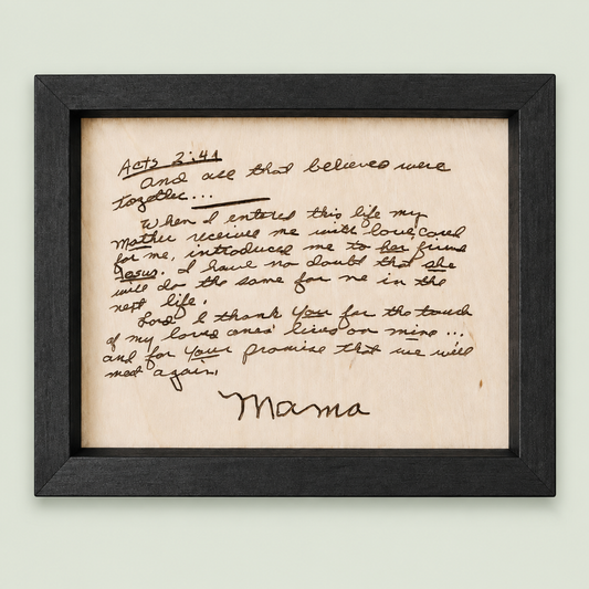 Black-framed wooden memorial keepsake engraved with a handwritten letter signed Mama on soft sage.