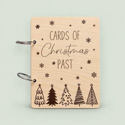 Wooden Cards of Christmas Past card keeper with five engraved trees, snowflakes and silver rings.