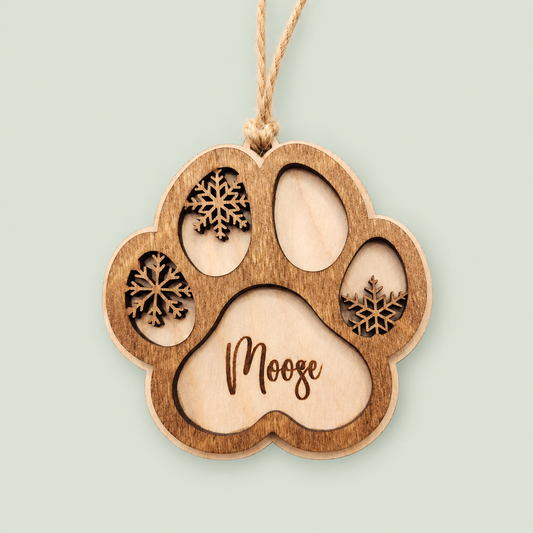 Layered wooden paw-print ornament personalized Moose, with three snowflakes.
