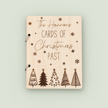 Personalized wooden Christmas card keeper for the Hannons with engraved snowflakes and five trees on soft sage.