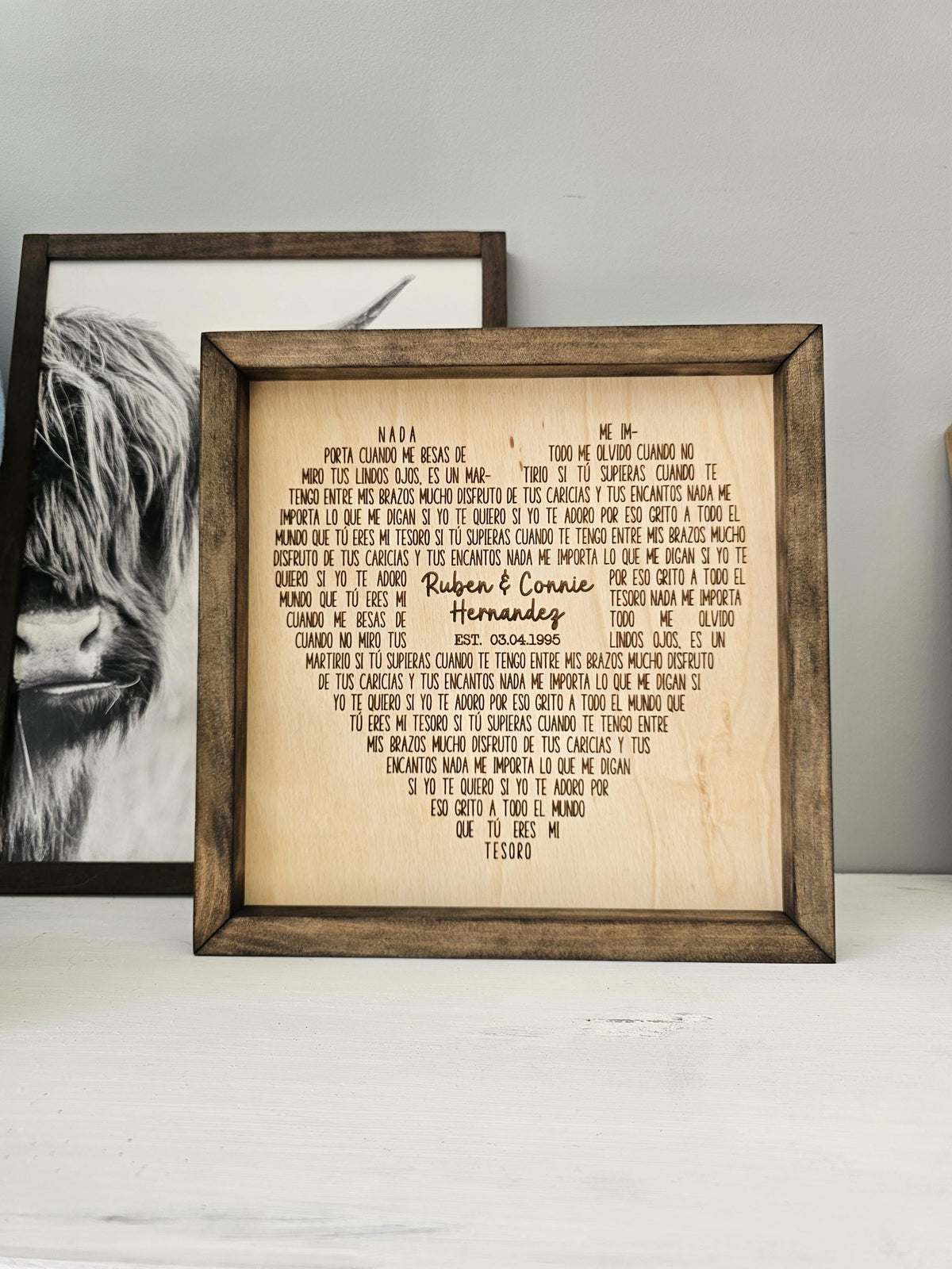 Framed wooden heart keepsake engraved with Spanish song lyrics and the names Ruben and Connie.
