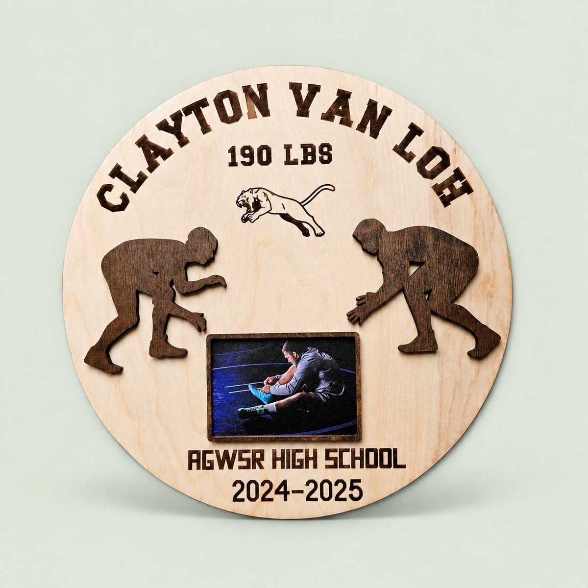 Personalized wooden wrestling award with athlete photo on a soft sage background