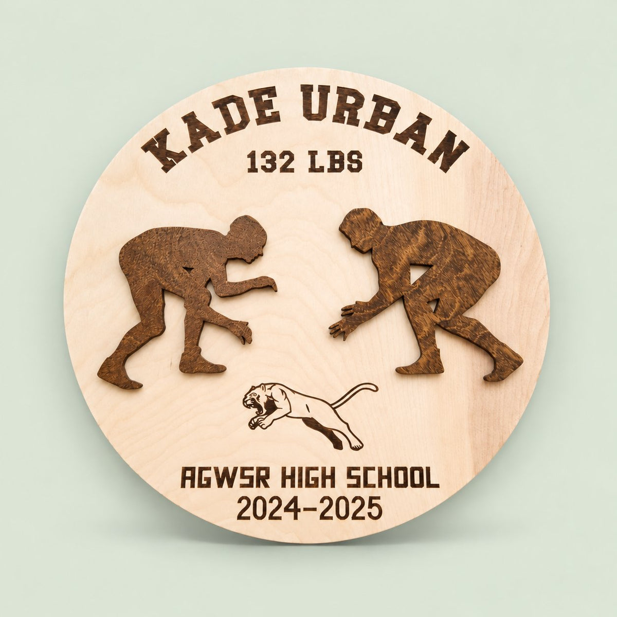 Personalized wooden wrestling award with wrestler name and weight class on a soft sage background