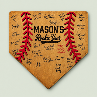 Wooden home plate guest book for a rookie year first birthday baseball party on soft sage.